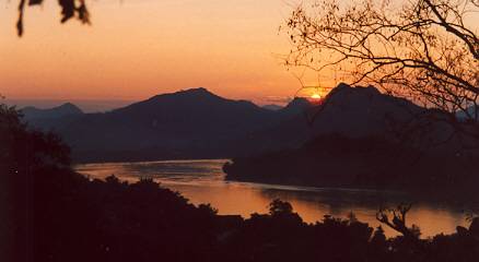 In fine weather, a small crowd gathers atop Phu Si to watch the sunset.