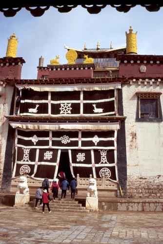Auspicious symbols cover the woolen curtains at this temple entrance.